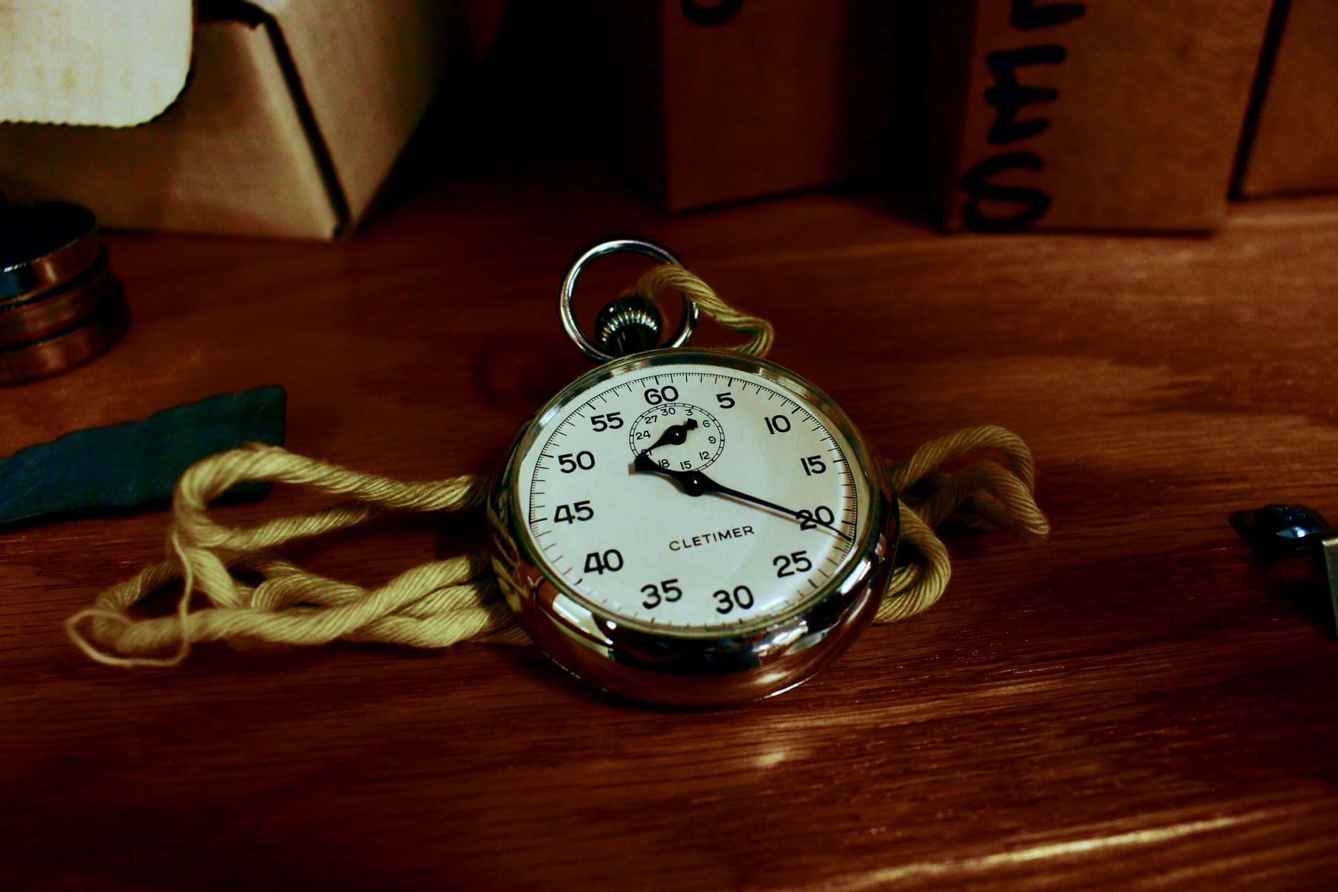 A stopwatch next to a laptop, representing website loading speed measurement.