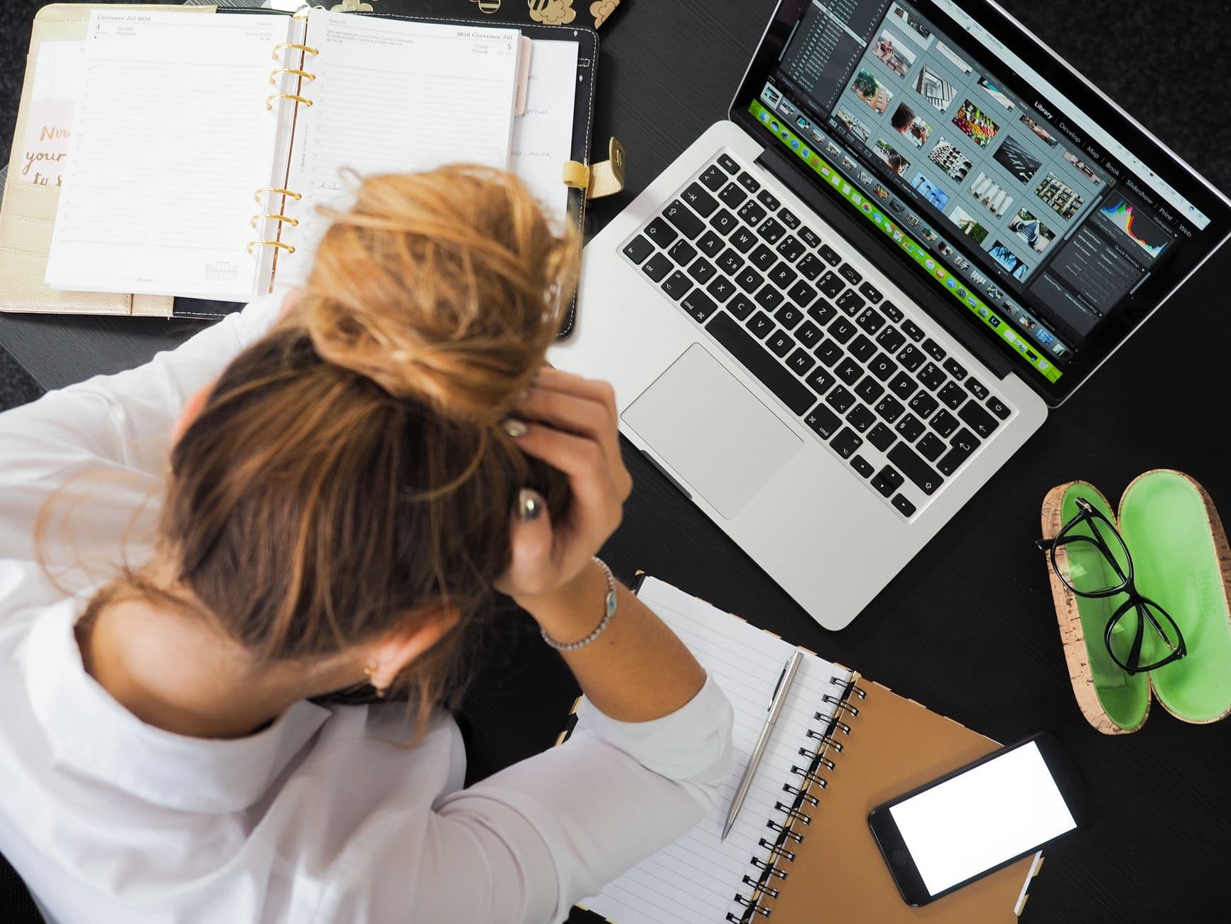 A small business owner looking frustrated while checking their website on a laptop.
