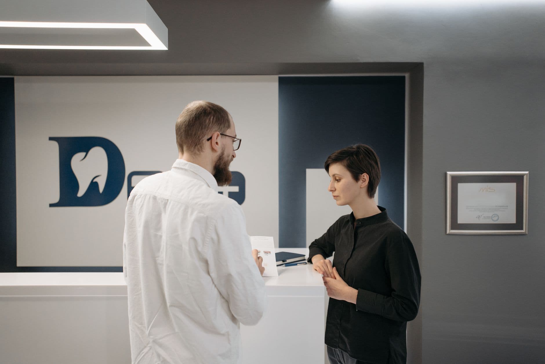 Dental office front desk conversation with a new patient - the moment dental SEO is built to win