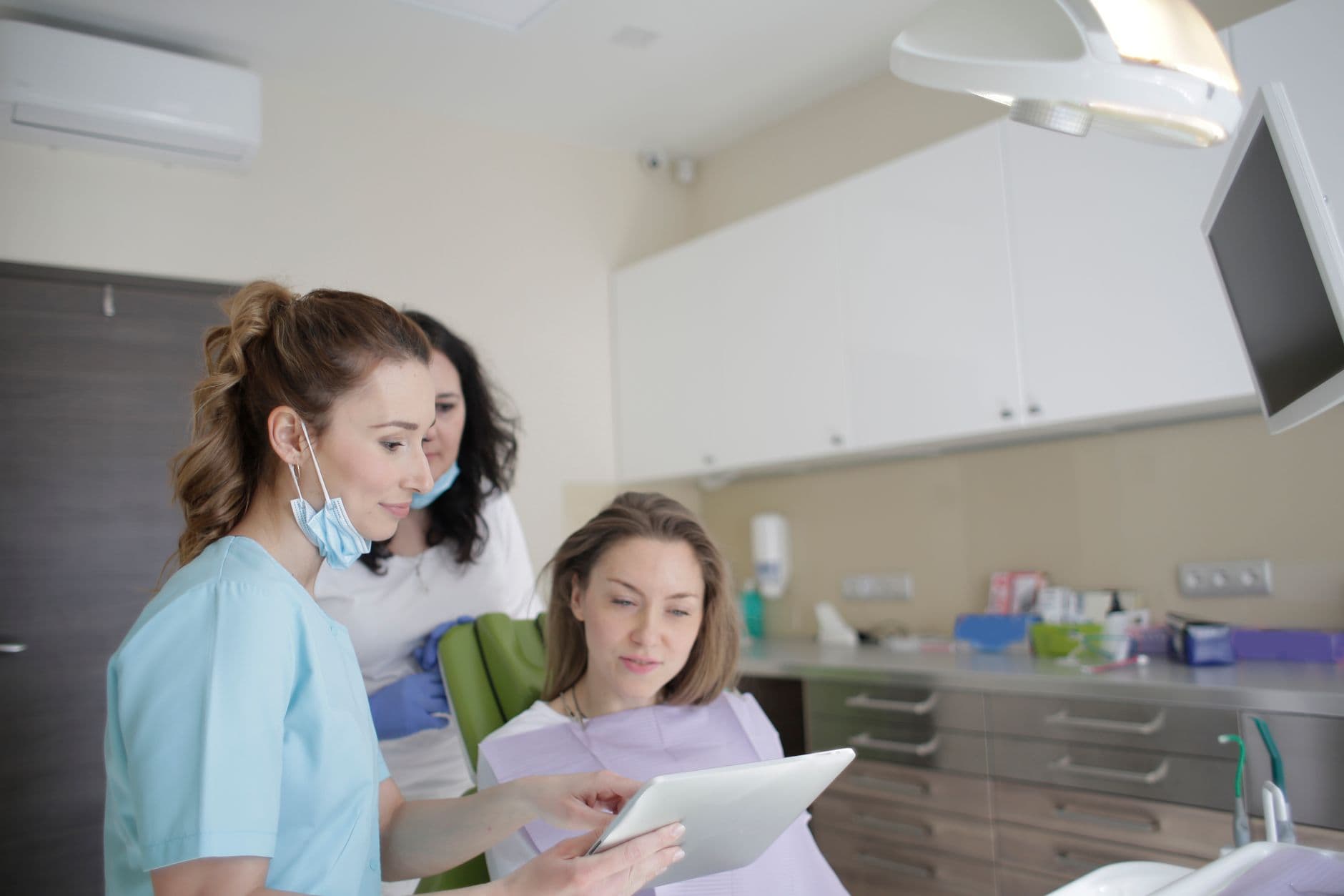 Dentist SEO services - dental team reviewing patient records at the front desk