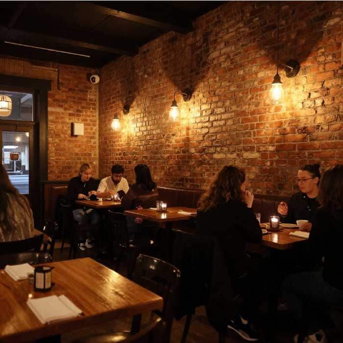Cozy restaurant interior in downtown Portland, Indiana with customers enjoying meals