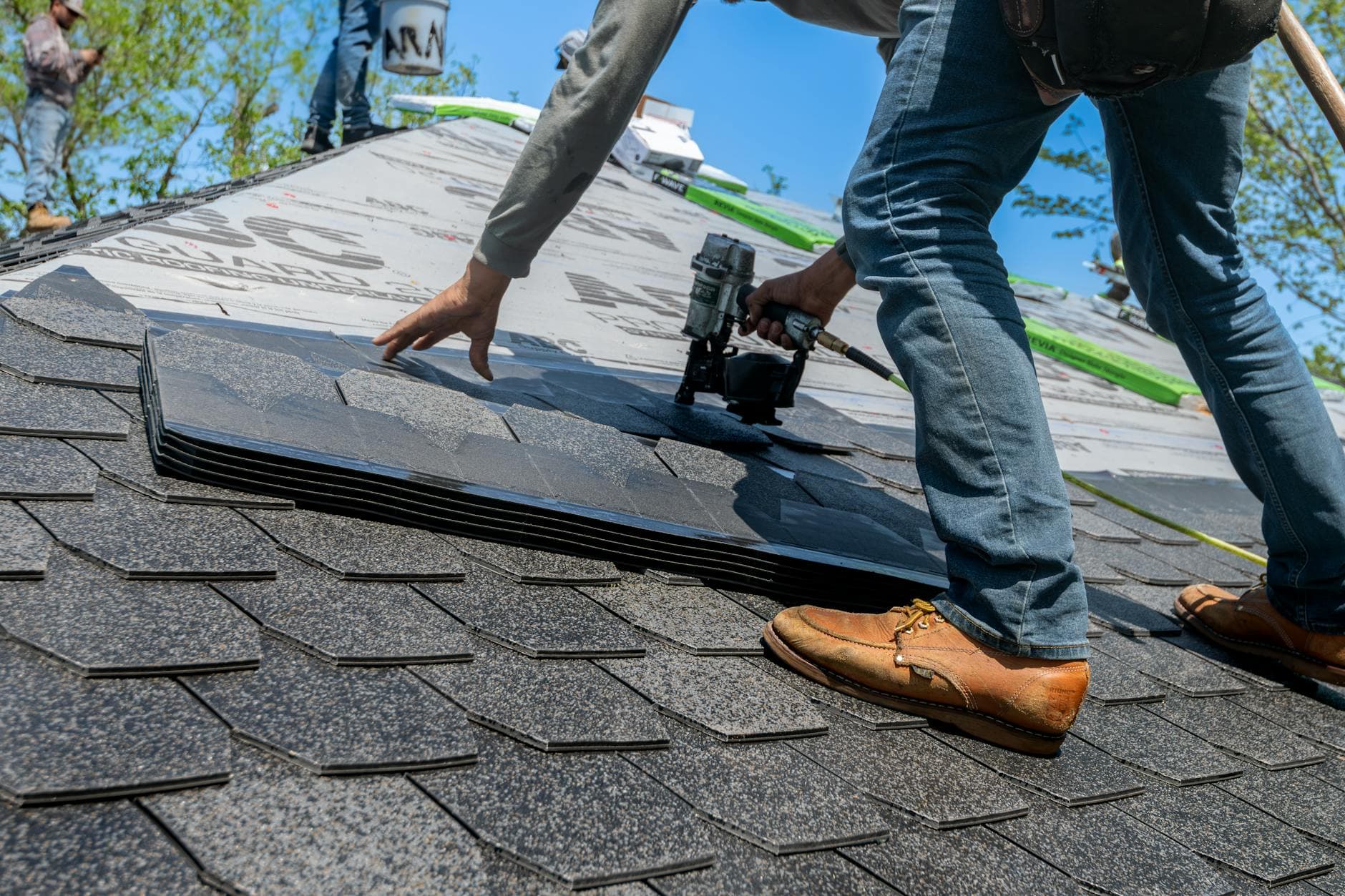 Roofing SEO services - roofer working on shingles, the kind of high-intent search BuzFind helps you win