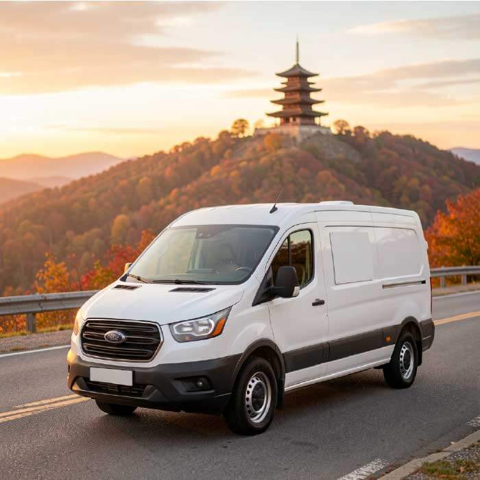 White plumbing service van parked with Reading Pagoda visible in background on Mount Penn